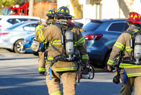 Firefighters walking in a parking lot